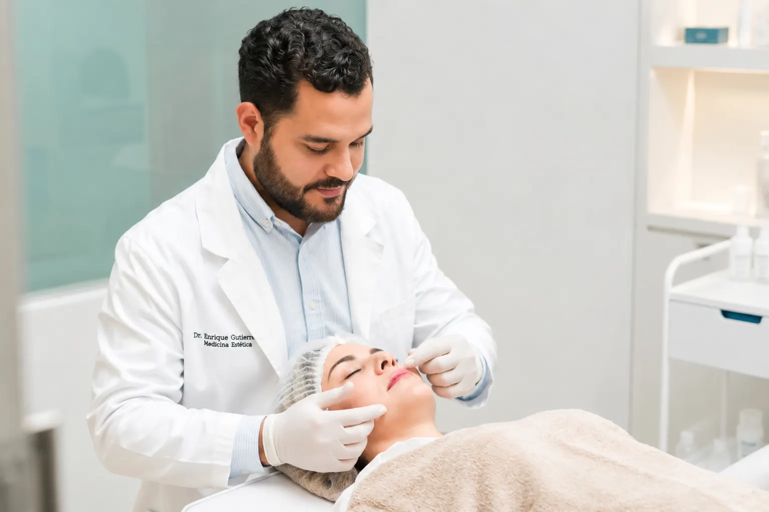 Dr. Enrique Gutiérrez realizando una valoración previa a un aumento de labios con ácido hialurónico en Alicante.